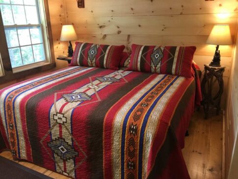 fish camp bedroom with red native american style bedspread