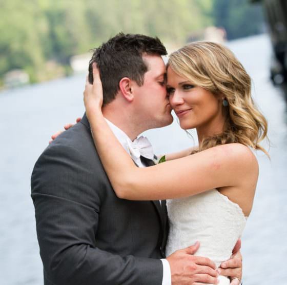 pride and groom at pavilion by the lake