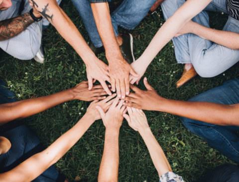 hands piled on top of each other showing team unity