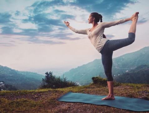 lady doing yoga on the mountain