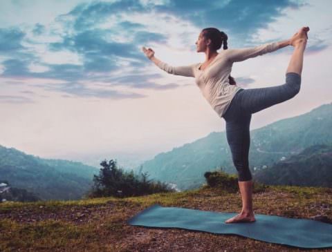 lady doing yoga on the mountain
