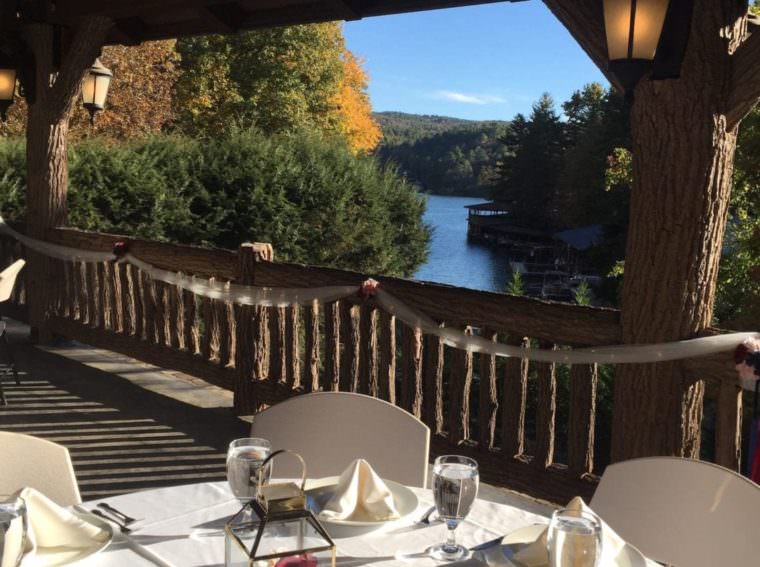 table set under the pavilion with a view of the lake