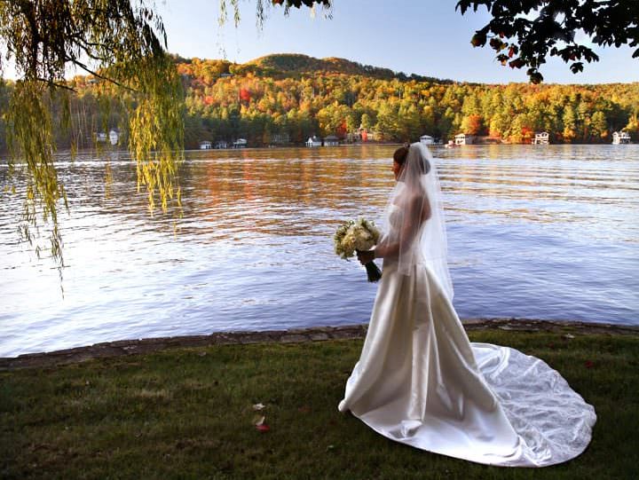 A woman in a wedding gown overlooking Lake Rabun