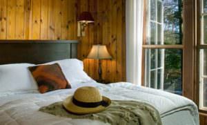 Tallulah Room with hat and green throw on bed