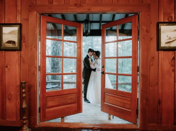bride and groom as seen through partially opened window